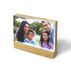 Wooden bamboo photo frame with a family portrait on a white background