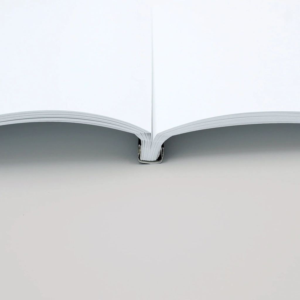 Open book on a white background with Black Spine cover by Peleman