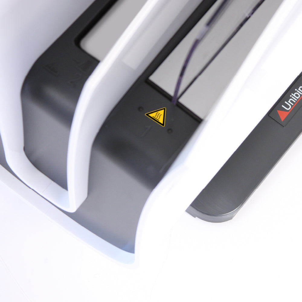 Close-up of a Peleman Unibody binder product with a warning label 